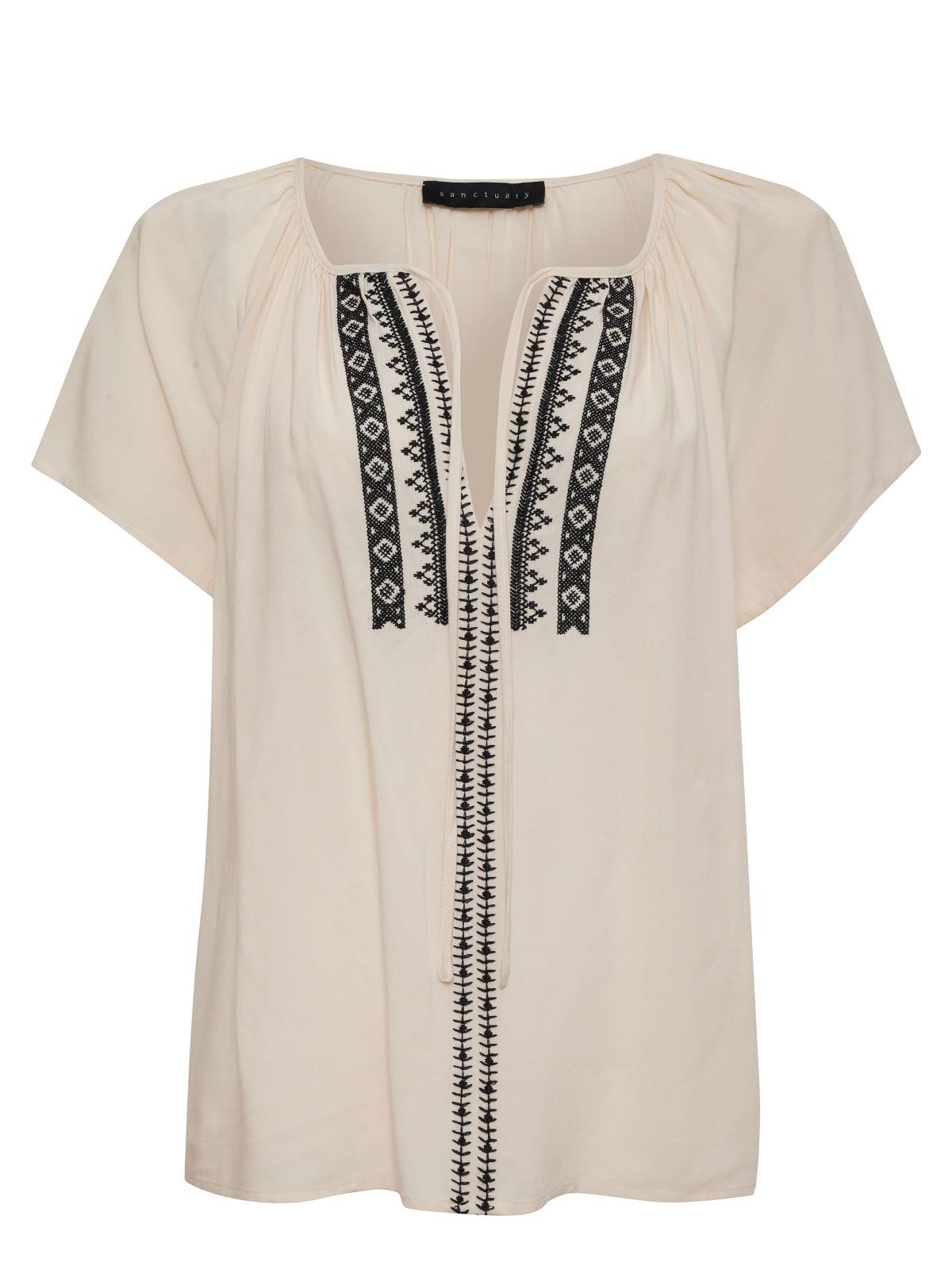 The Golden Dream Top Birch from Sanctuary Clothing's Inclusive Collection is a cream-colored short-sleeve blouse featuring black geometric embroidery down the front. Its rounded neckline is gently gathered and includes a keyhole at the top.