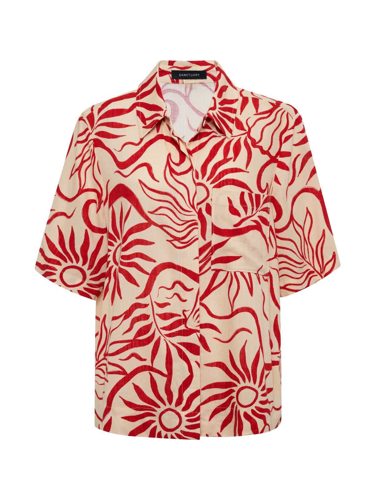 The Sanctuary Clothing relaxed vacation shirt sunny riviera is a short-sleeved, button-up with a collar, single chest pocket, and beige background featuring bold red sun and wave patterns.