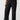 A person wearing Sanctuary Clothing's Reissue Cargo Pant Black from the Inclusive Collection, featuring a high-waisted fit with multiple pockets and a relaxed, wide-leg silhouette. They have paired it with a black-and-white printed top and are standing confidently with one hand on their hip and the other in their pocket. Completing the look, they are wearing black flats.