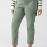 A person wearing the Sculpted Hayden Cargo Dark Spruce pants from Sanctuary Clothing's Inclusive Collection paired with a striped long-sleeve shirt. The high-waisted cargo pants have multiple pockets and a relaxed fit. They are styled with black ballet flats, set against a plain white background.