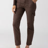 A person wearing the Sculpted Hayden Cargo Brown Sugar pants by Sanctuary Clothing is shown from the shoulders down against a plain background. The high-waisted brown cargo pants feature front and side pockets. They are also wearing a long-sleeved brown top and brown flats. One hand is placed in a pocket, while the other rests by their side.