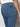 A close-up shot features someone wearing the "sculpted hayden straight crop best in show" jeans by Sanctuary Clothing and a white top. The focus is on the back pocket area, adorned with a small black label, as the individual stands against a neutral background.