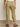 A person is seen from the rear in Sanctuary Clothing's "Take Over" linen jogger pants in bamboo, paired with a casual white top and brown sandals, against a neutral background.
