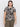 A person with long dark hair wears Sanctuary Clothing's "the perfect tee mirage extended sizing," featuring a black and beige pattern, paired with dark pants. They're posed against a plain white background, facing the camera.