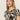 A person with long, straight hair wearing Sanctuary Clothing's "the perfect tee mirage," featuring a beige and black abstract pattern, looks calmly at the camera against a plain, light background.