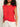 A woman with curly hair wears the Sanctuary Clothing knotted muscle tee in cayenne and white drawstring pants, standing against a plain background with her face partially out of frame.