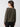 A person with long, dark hair stands facing away, showcasing the "Everyday Openwork Sweater Kalamata" by Sanctuary Clothing. The dark green, textured long-sleeve top features a ribbed hem and cuffs. They are also wearing black pants against a plain light grey background.