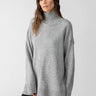 A person is wearing the Perfect Tunic Heather Ash from Sanctuary Clothing, posing against a plain white background. The tunic features an oversized fit with ribbed cuffs and hem. With long dark hair, the individual is looking directly at the camera.