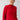 A person wearing the Cable Mock Neck Sweater in Mars Red by Sanctuary Clothing stands against a plain background. They have blond hair pulled back and are gazing off to the side. The sweater boasts a textured pattern along with ribbed cuffs and hem.