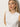 A person with long, blonde hair is wearing Sanctuary Clothing's sequin knitwear shell sweater in white. Standing against a plain background, they have a neutral expression and are looking slightly to the side, accessorized with small hoop earrings.