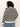 A person with curly hair is shown from the back, wearing the Sanctuary Clothing open knit bomber jacket macrame black stripe (extended sizing) and light blue denim pants against a plain light background.