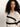 A woman with long, curly hair is wearing the "Openwork Tee Black Chalk Stripe" by Sanctuary Clothing. She's looking to her right, with a neutral expression, against a light background.