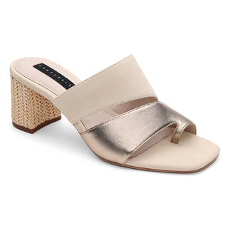 The Brisk Sandal Nude Bronze Sand Dollar by Sanctuary Clothing is a stylish sandal featuring a chunky woven block heel and an open-toe design with two straps. The upper strap is light beige suede, while the lower one exudes elegance in metallic silver. The insole appears padded for added comfort, and the distinctive heel brings a touch of uniqueness.